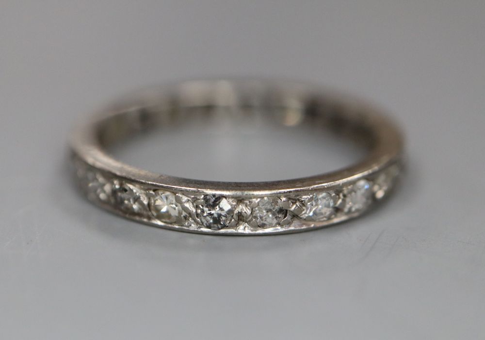 A white metal and diamond set full eternity ring, size O, gross 2.8 grams.